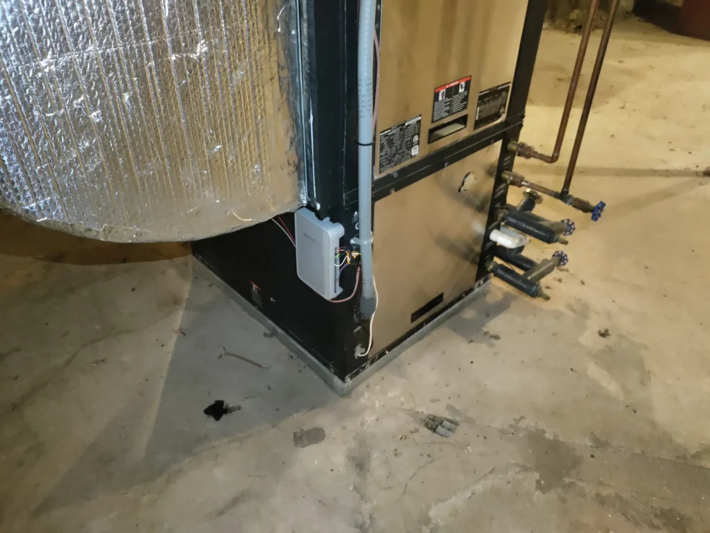 Geothermal heat pump cabinet and ductwork in a New Hampshire basement