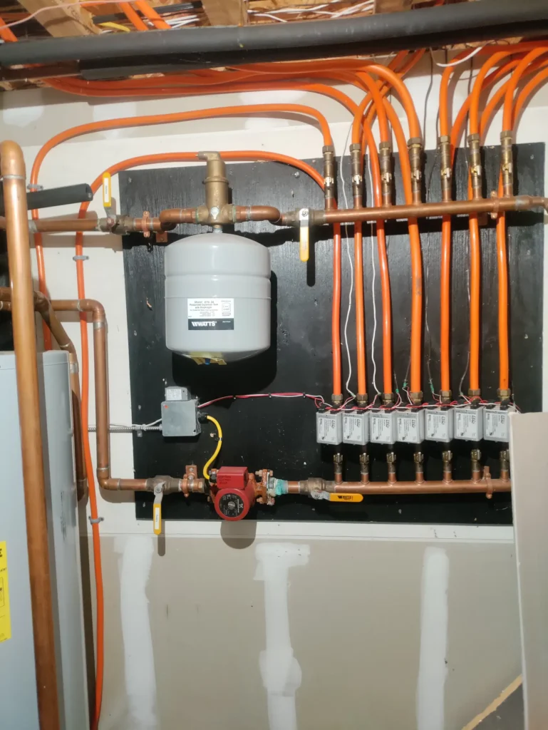 Hydronic piping and controls connected to a geothermal heating system