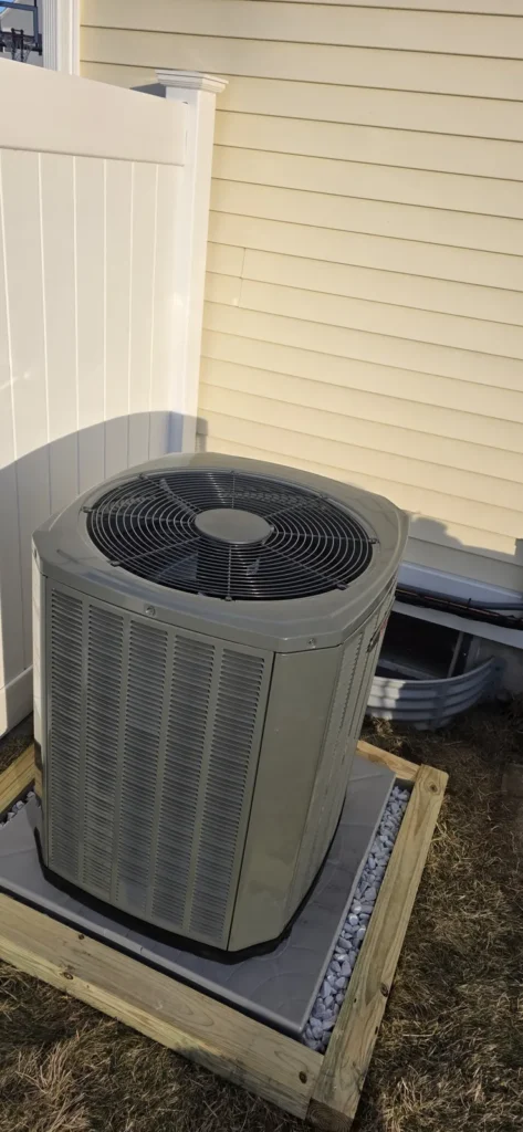 Air conditioner condenser installed on a pad
