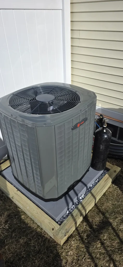 Air conditioner condenser on a composite pad