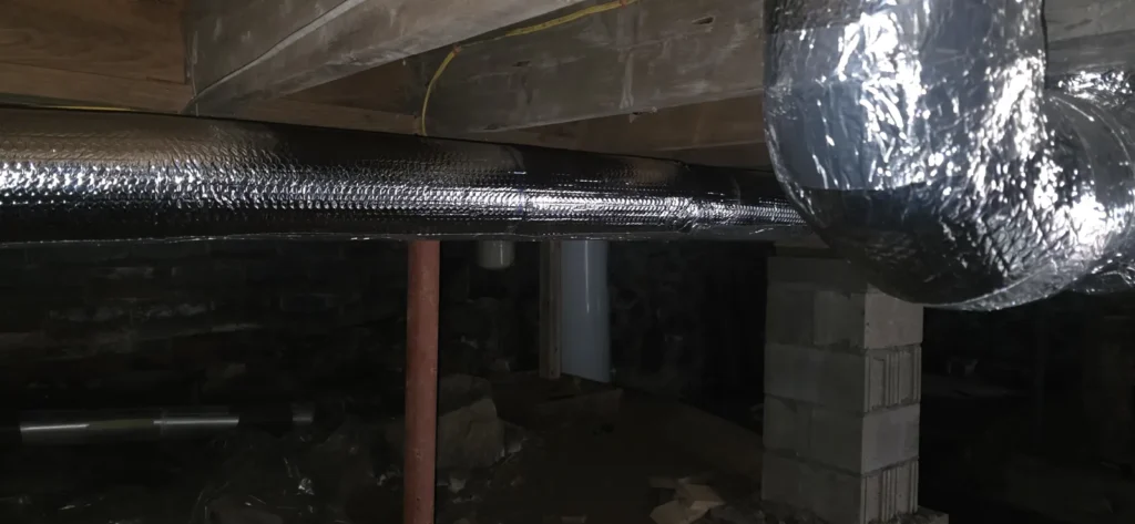 Duct runs leaving an air handler along basement joists
