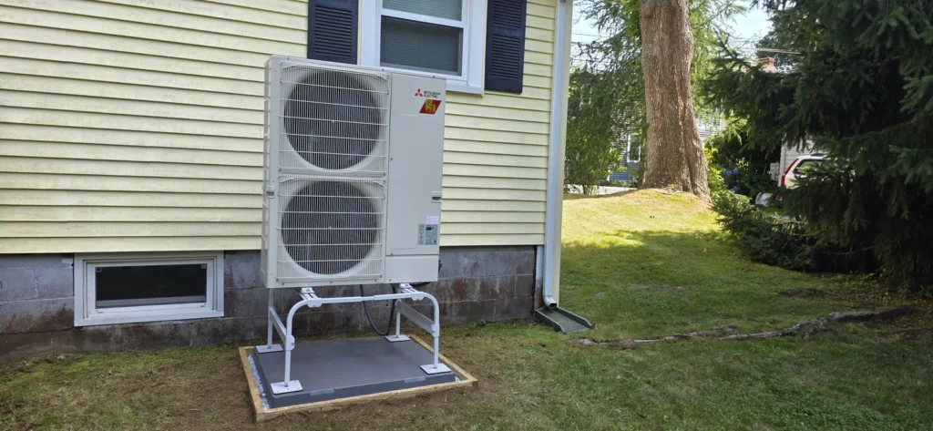 Cold-climate heat pump outdoor unit on a raised stand