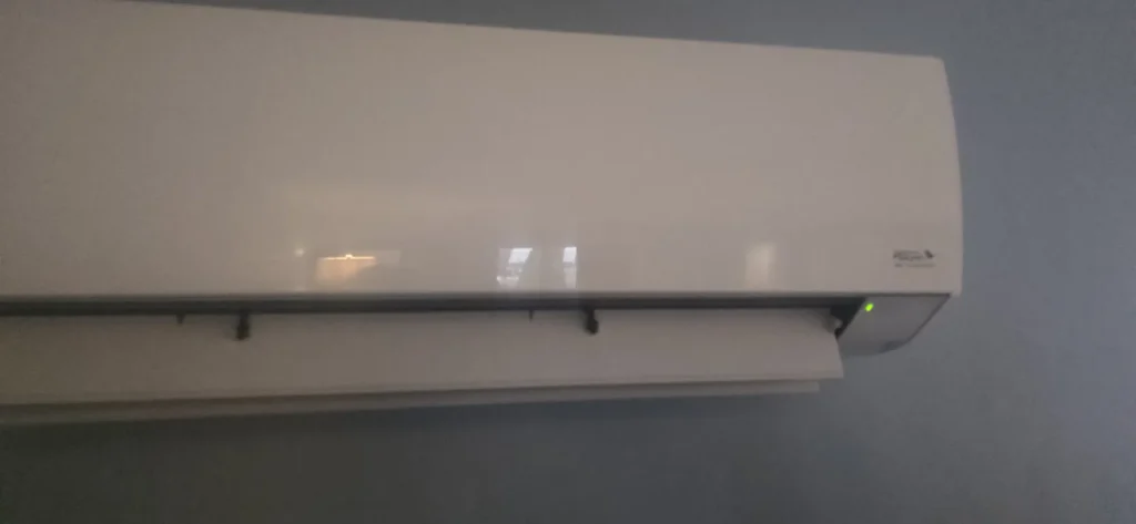 Ductless mini-split indoor unit mounted high on a wall