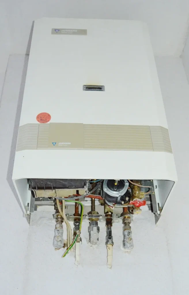Wall-mounted gas boiler with front cover removed for service