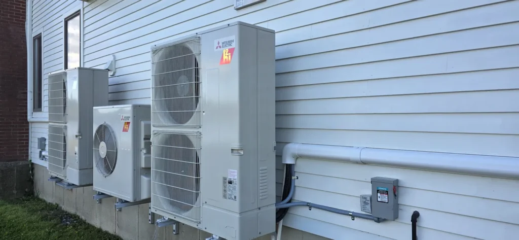 Mini-split heat pump outdoor unit beside a house