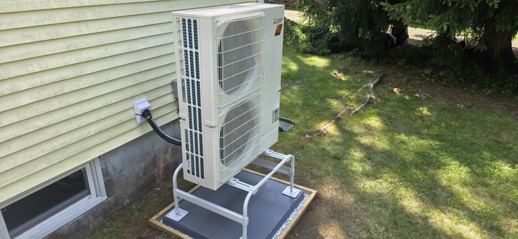Heat pump outdoor unit installed beside a home