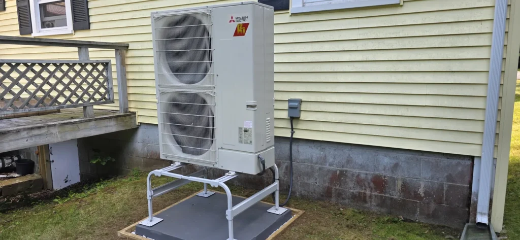 Heat pump outdoor unit on a snow stand with clear surroundings