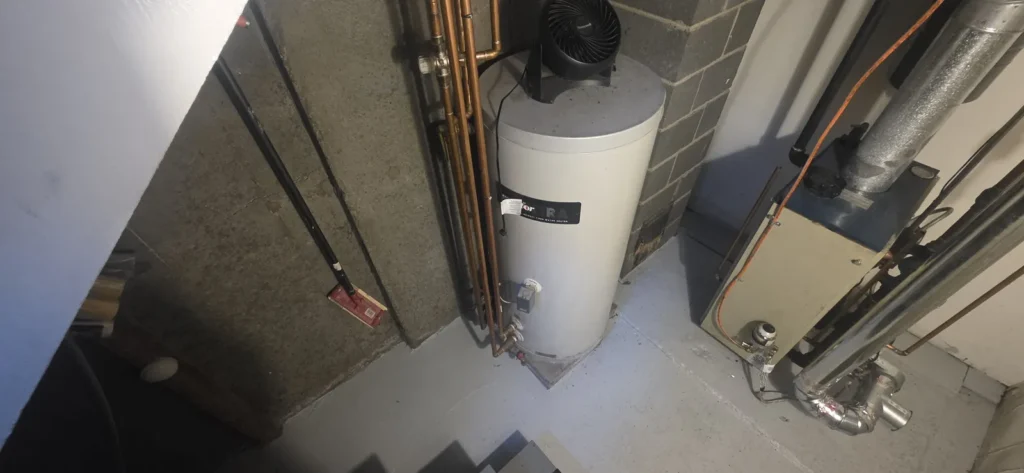 Indirect water heater installed beside a boiler