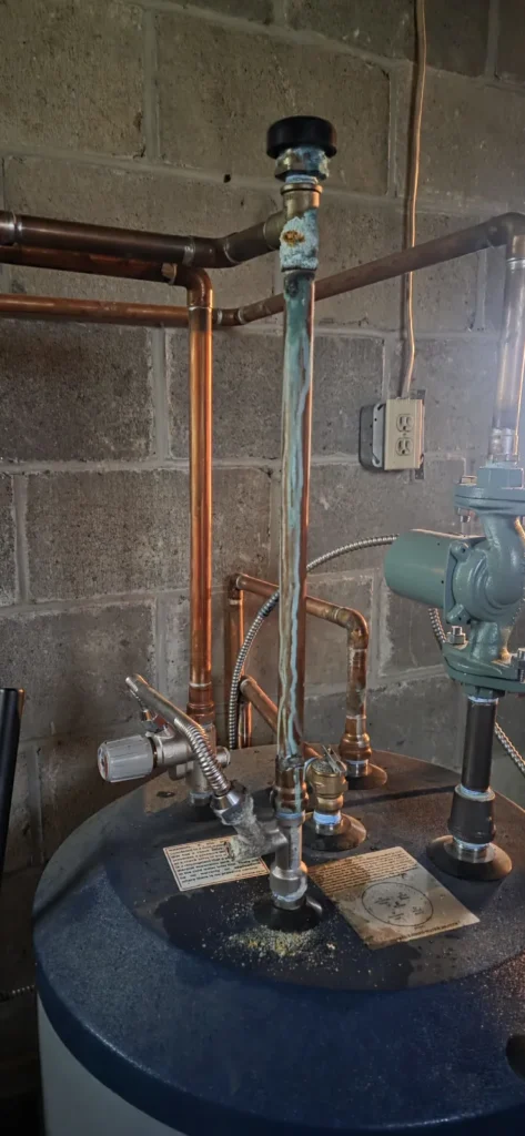Water heater installed alongside boiler piping