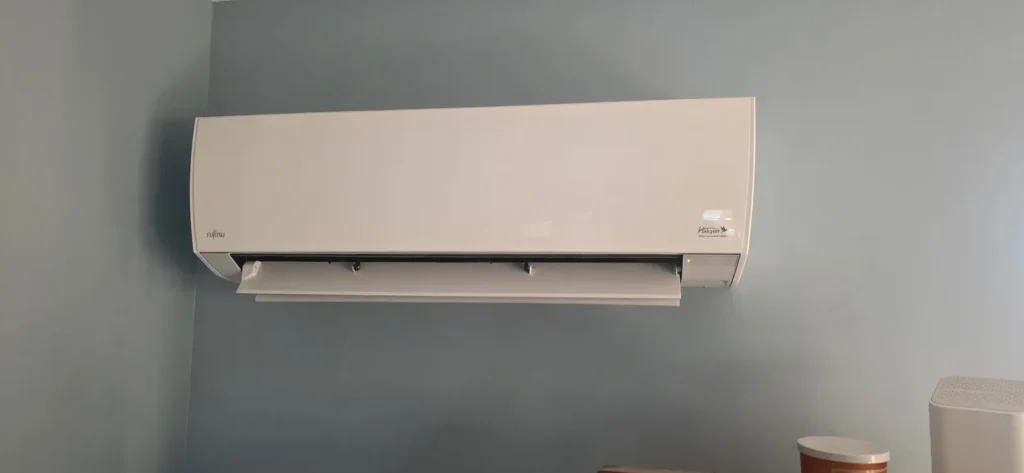 Ductless mini-split indoor unit on a gray wall