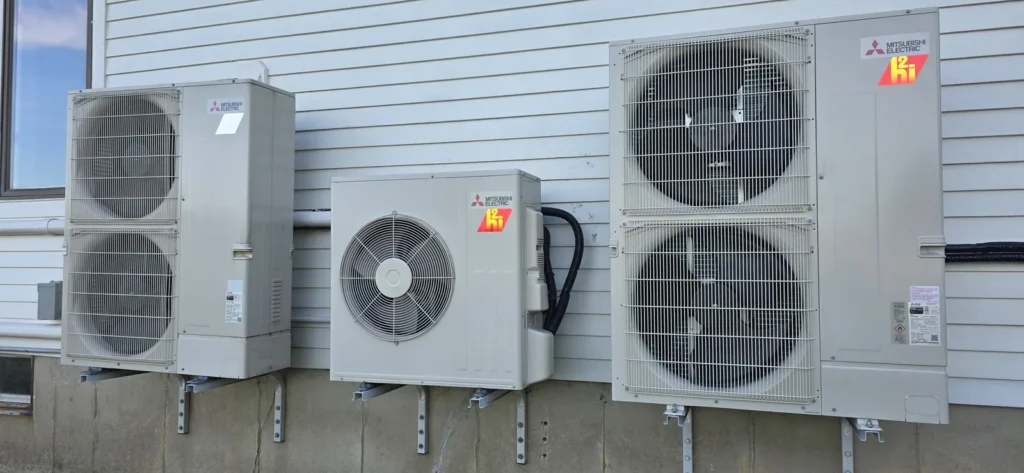 Mini-split outdoor unit on a stand beside a home