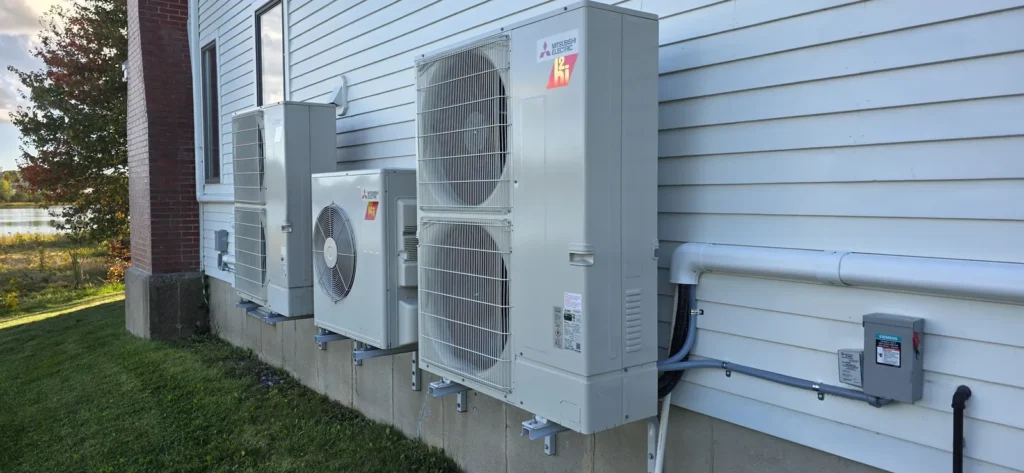 Mini-split outdoor unit on a pad beside a lawn