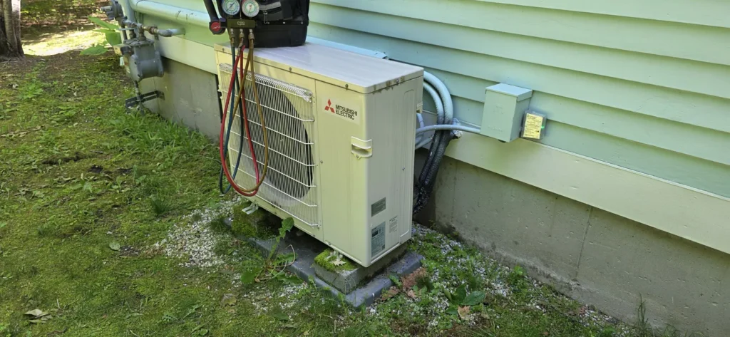 Mini-split outdoor unit beside a home
