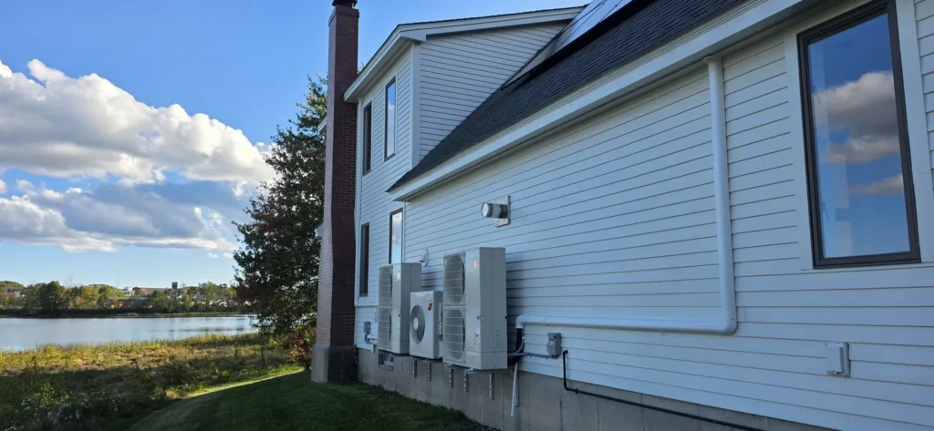 Mini-split outdoor units installed along a house