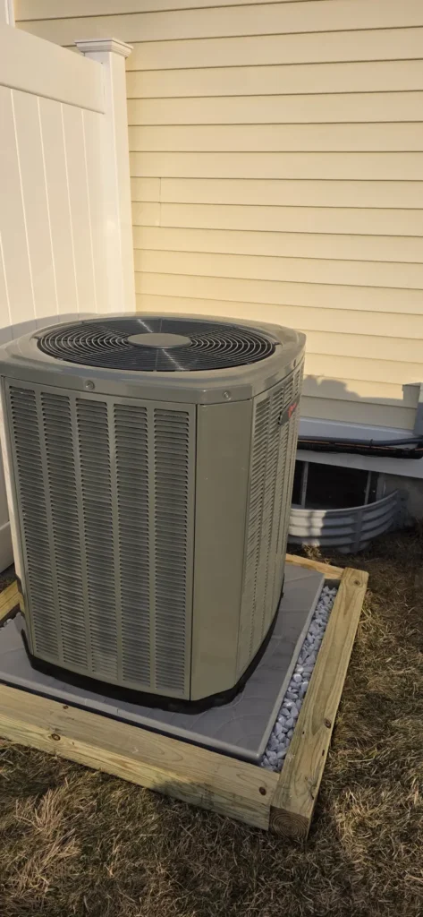 New air conditioner condenser on a pad