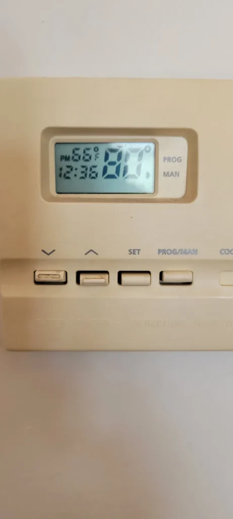 Programmable wall thermostat for a home heating system