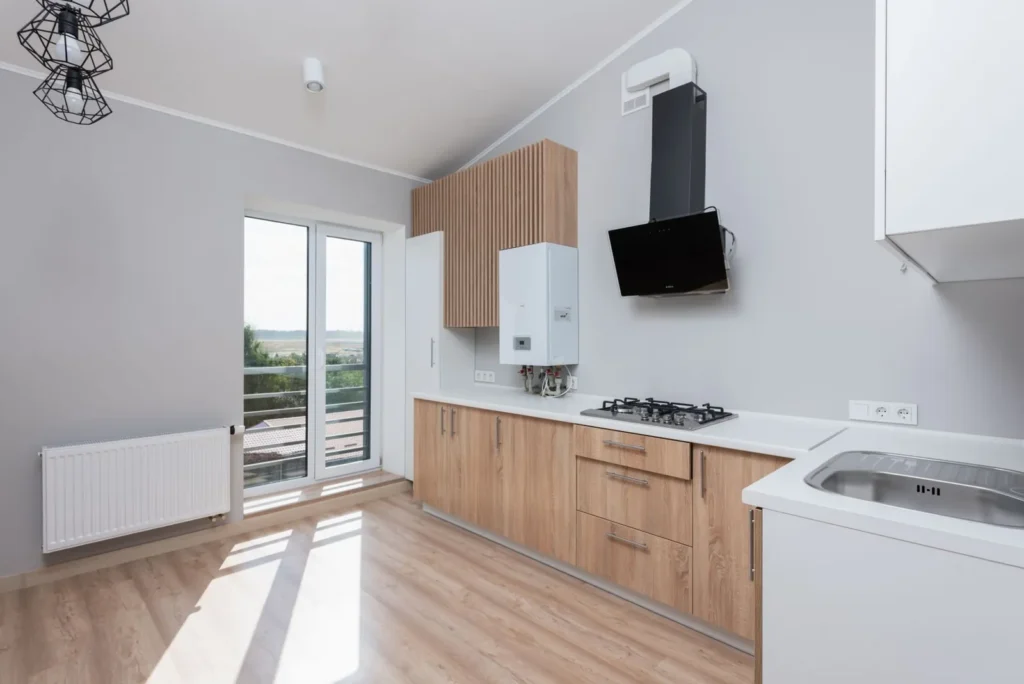 Wall-mounted tankless gas water heater in a bright modern kitchen